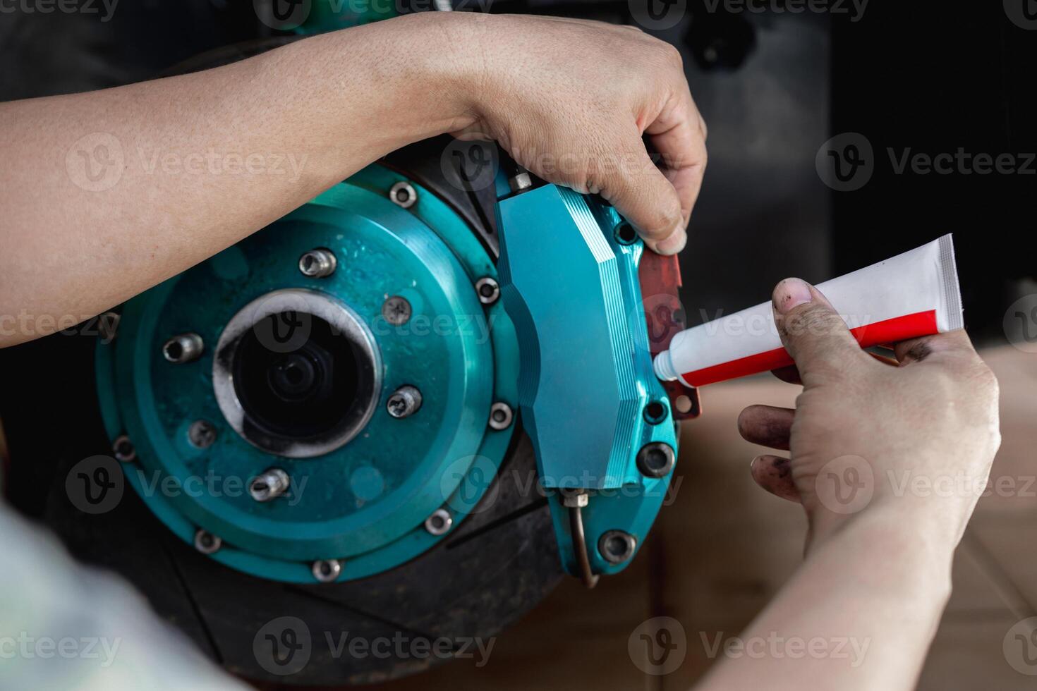 Disk brake service concept Close up hand a man use Grease Antiseize to