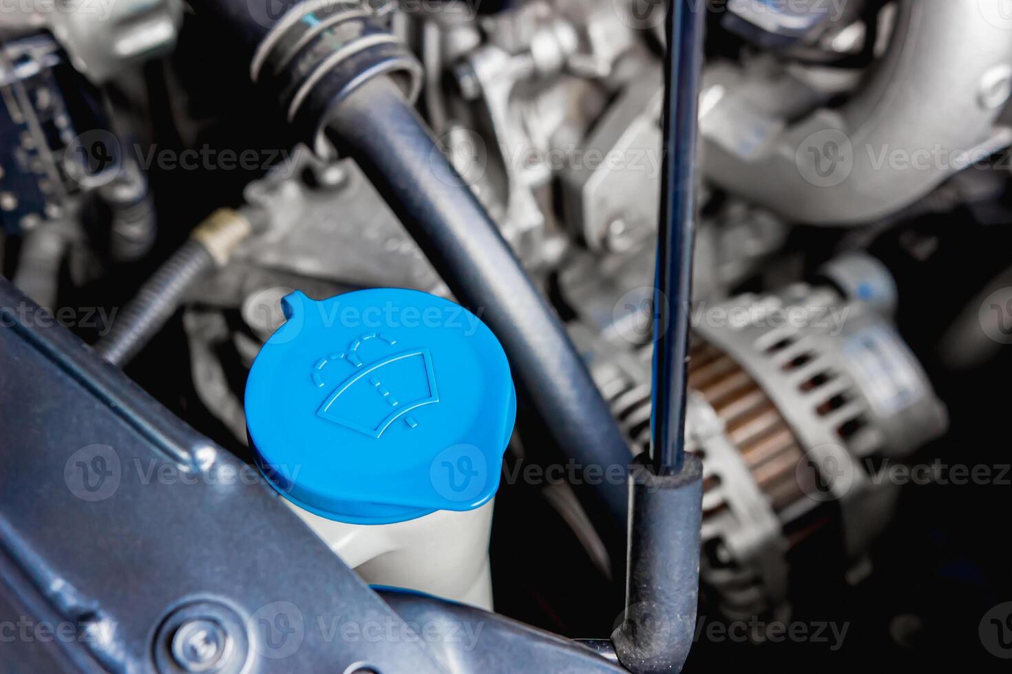 Close up wiper tank in engine room for check water level for Clean the windshield of car basic of service concept photo
