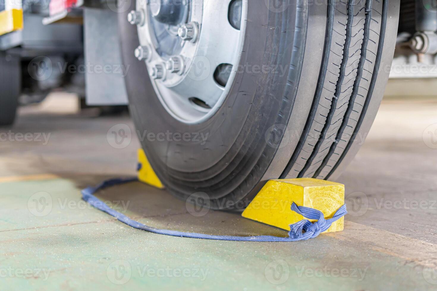 Truck wheel and Temporary Stopper of prevent the vehicle from moving of parking for safety in transportation work photo