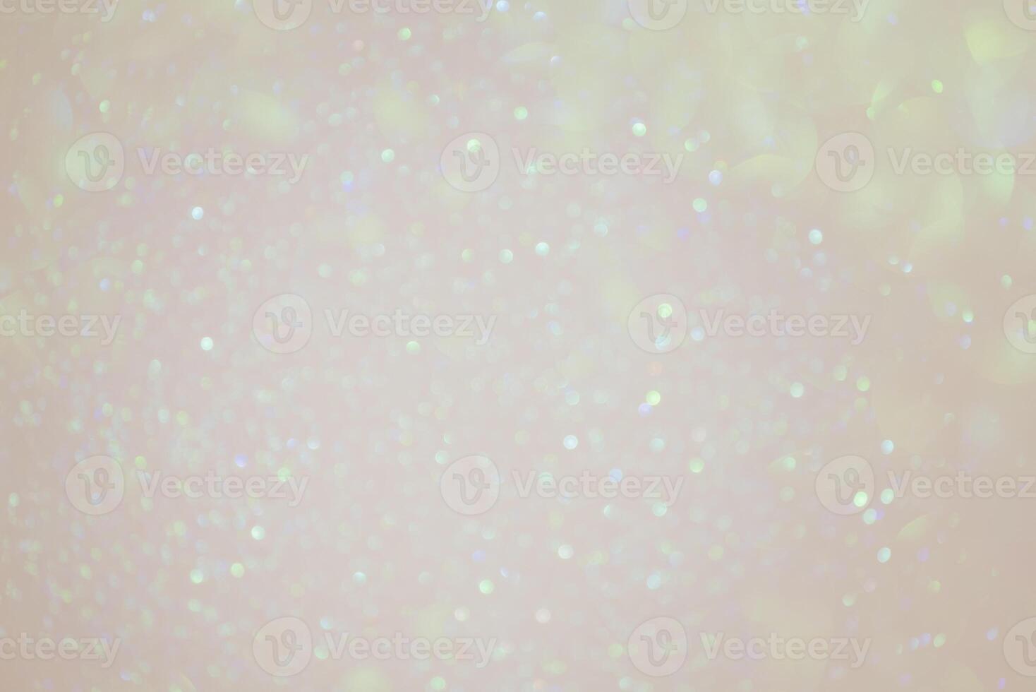 Beige background with green defocus lights. Abstract glitter background. Bokeh photo