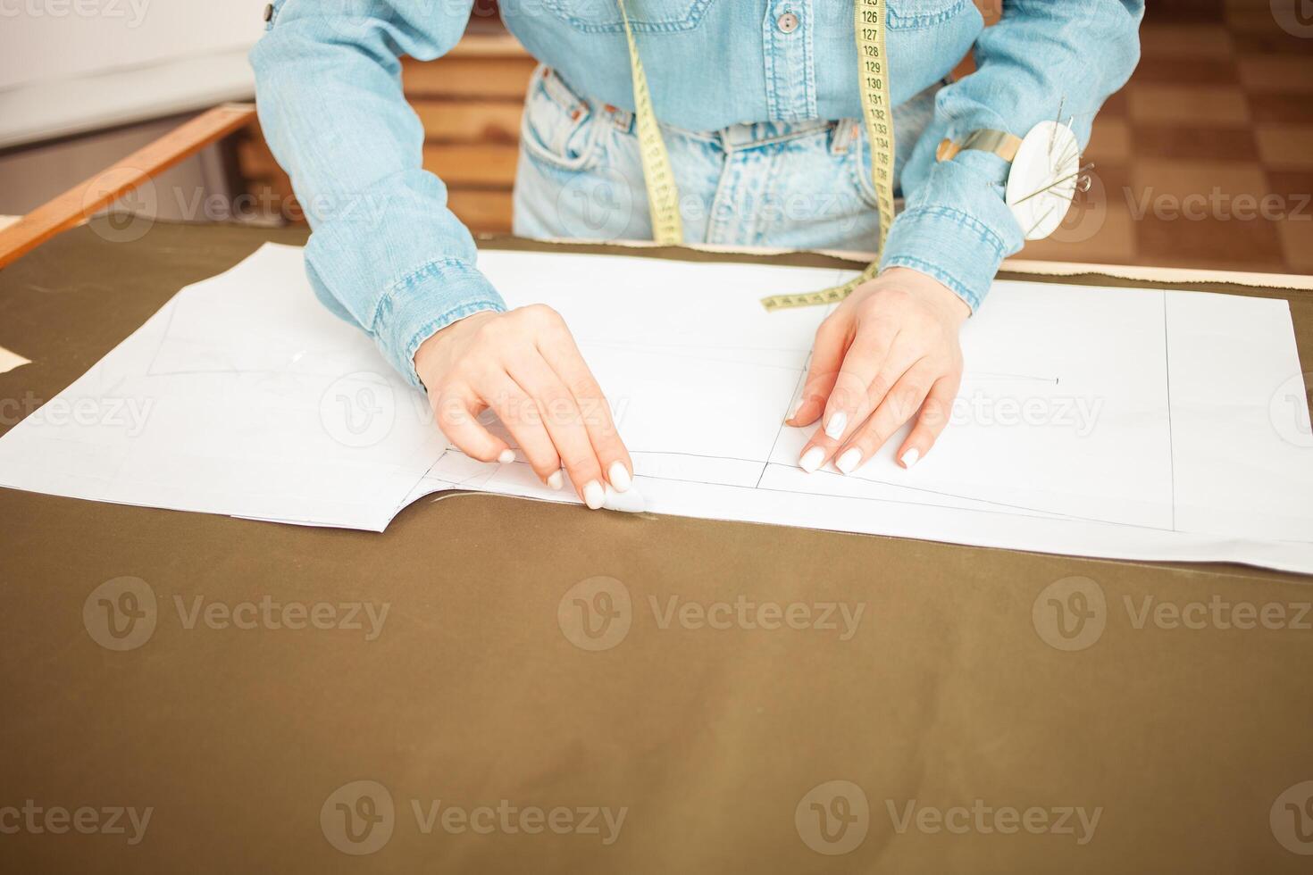 Seamstresses make sketch, pattern on fabric. Atelier, tailoring of individual clothes, small business. contour soap, chalk. photo