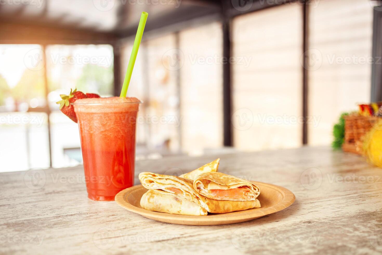 Summer refreshing drink, fruit strawberry frappe, smoothie, juice, ice and sparkling water. pancakes with fish photo