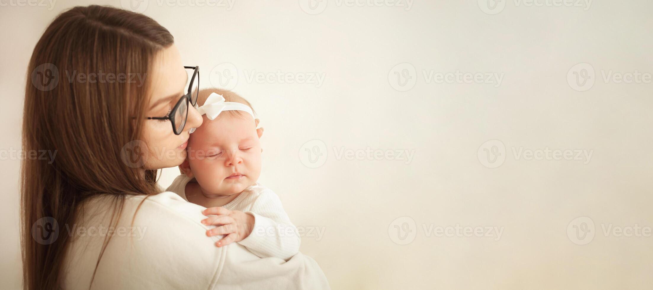 mother plays with newborn baby photo