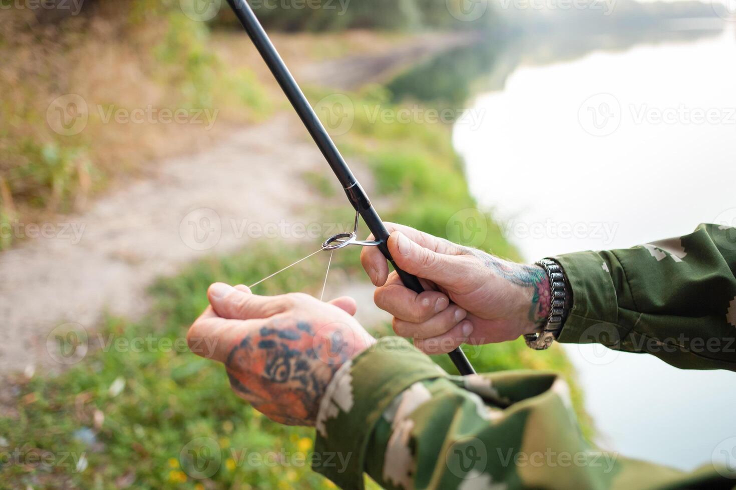 pensioner collects a fishing rod. Instruction, collection process. Copy space, senior concept. Outdoor, beautiful scenery. threads photo