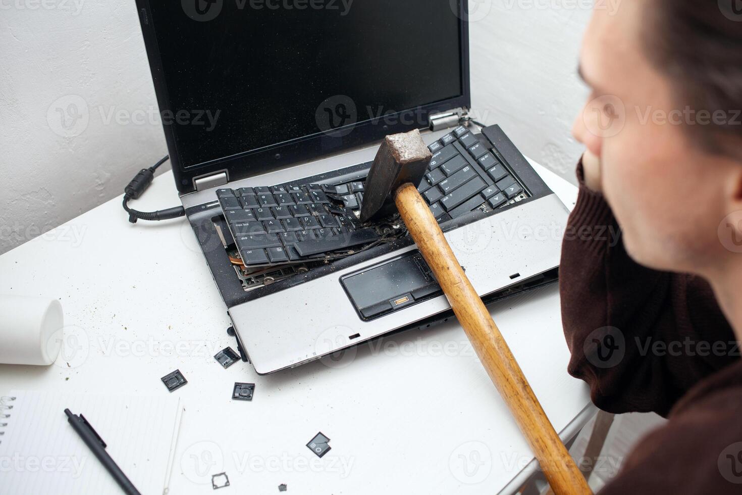 man destroyed laptop with a hammer. Nervous work, buggy computer, errors, slow Internet, not saved in the game, printed text, hung. Bad old computer failed, does not turn on, photo
