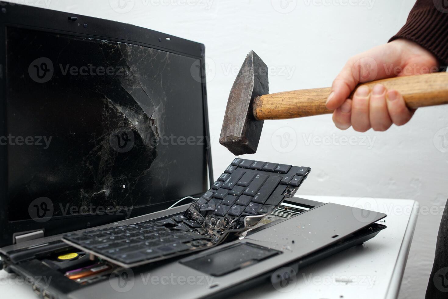 man destroyed laptop with a hammer. Nervous work, buggy computer, errors, slow Internet, not saved in the game, printed text, hung. Bad old computer failed, does not turn on, hangs. keyboard photo