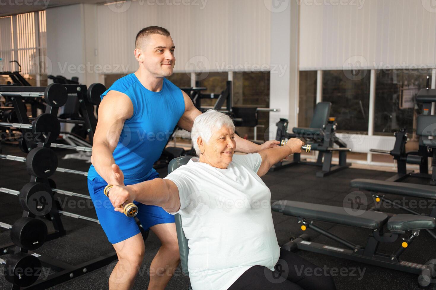 An elderly pensioner plays sports in the gym photo