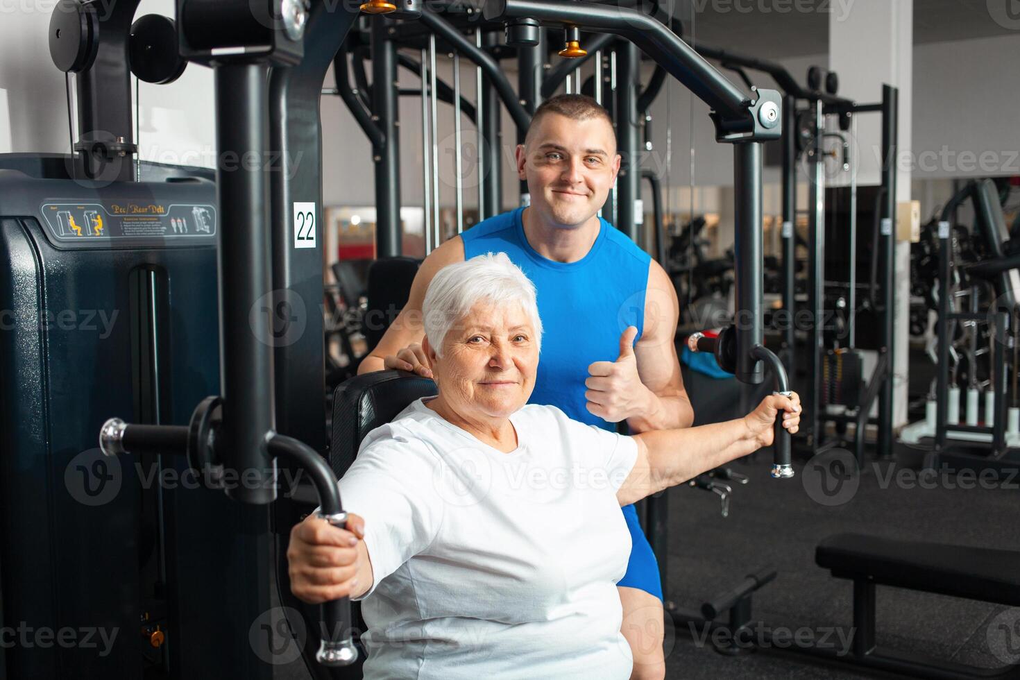 An elderly pensioner plays sports in the gym photo