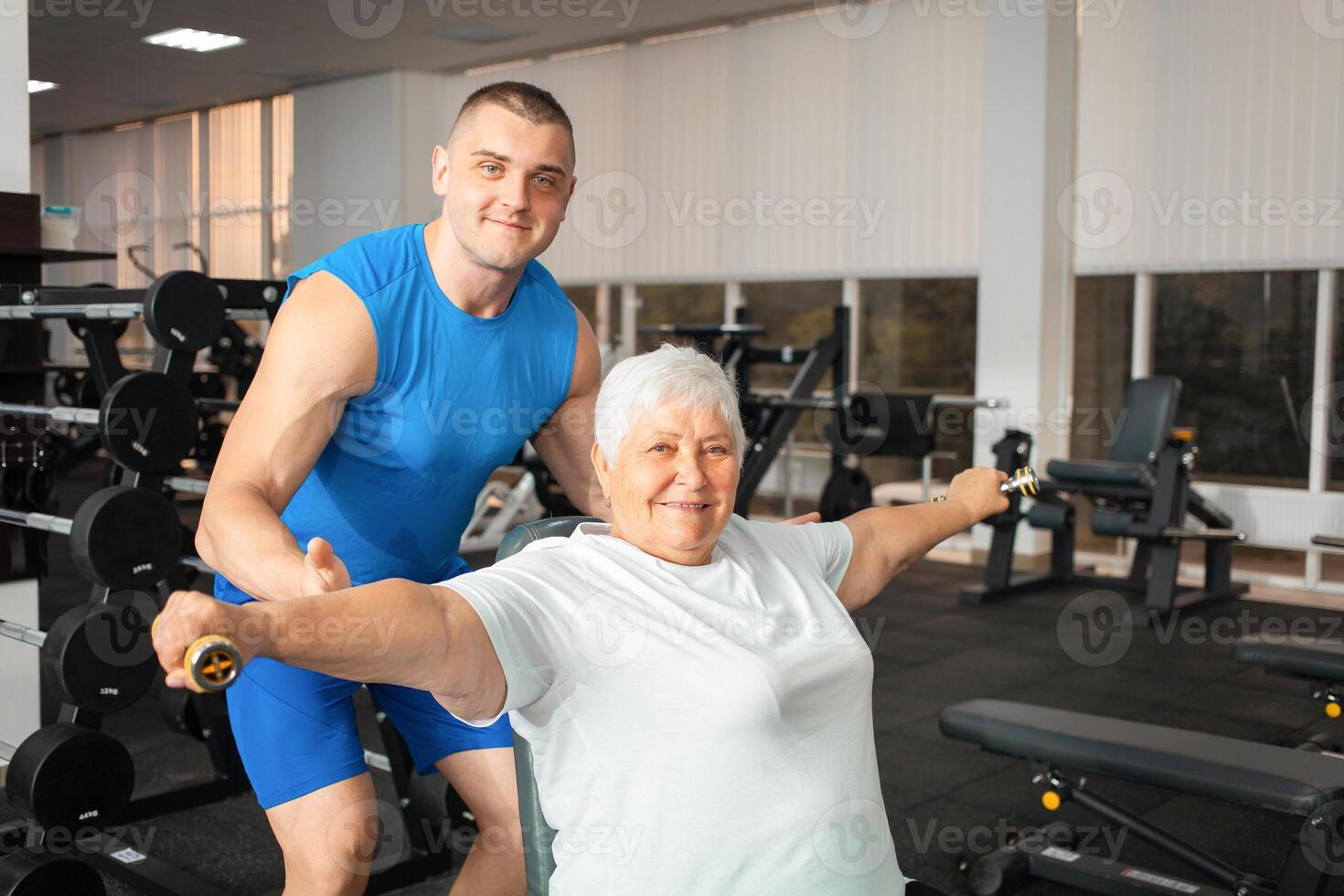 An elderly pensioner plays sports in the gym photo