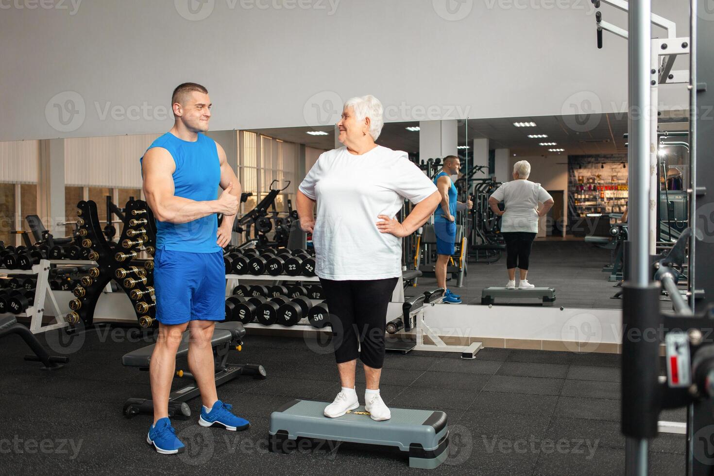 An elderly pensioner plays sports in the gym photo