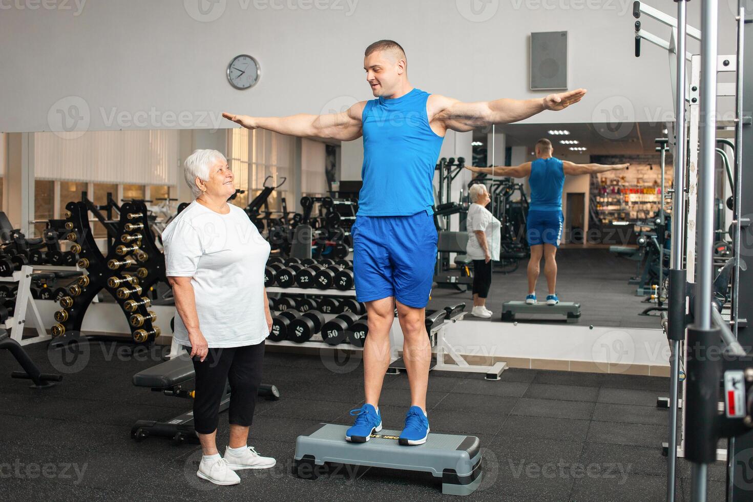 An elderly pensioner plays sports in the gym photo