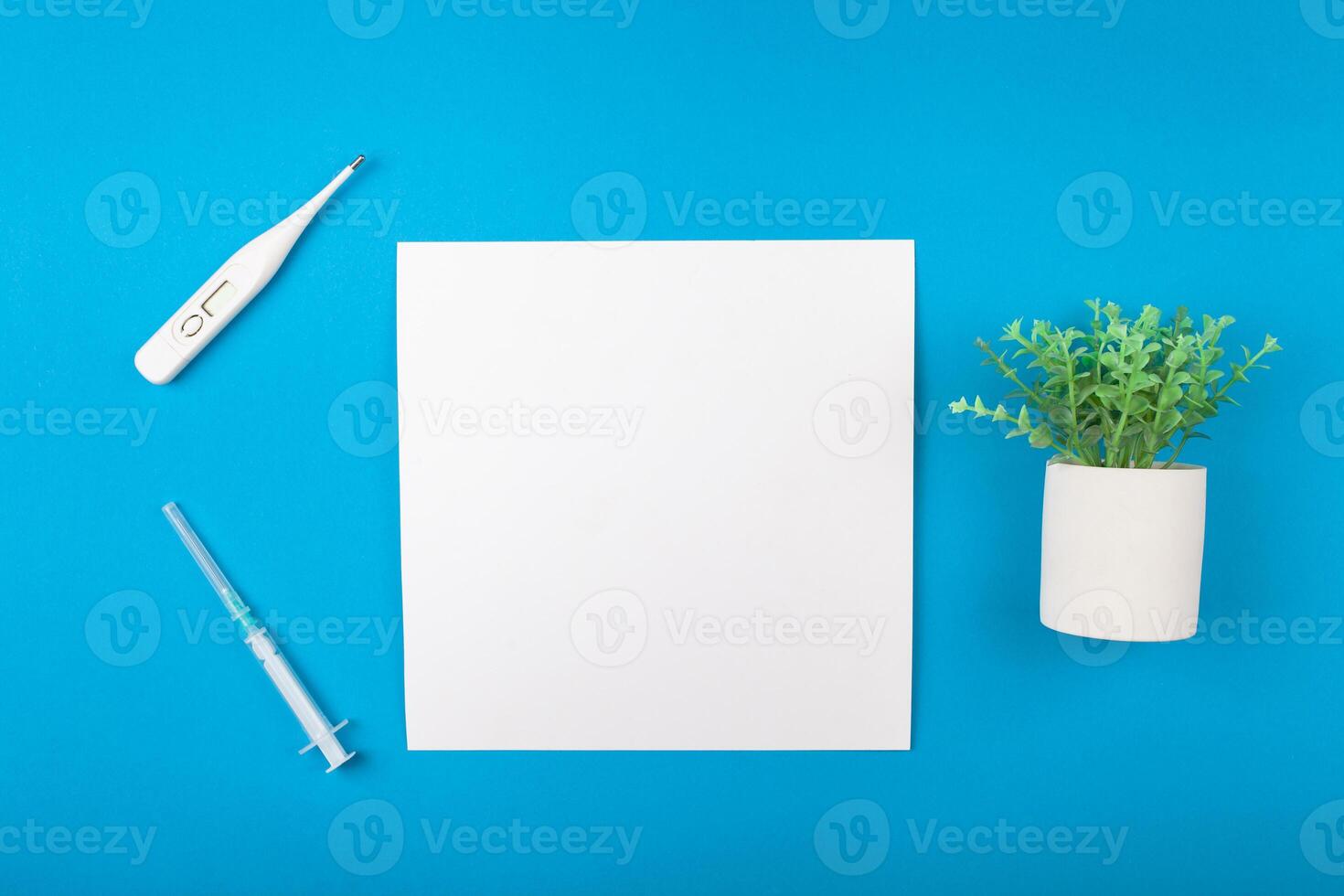 Mocup medicine on a blue background. phonendoscope, medical supplies. flat lay empty space for text. Advertising, design, post. Green artificial plant succulent photo