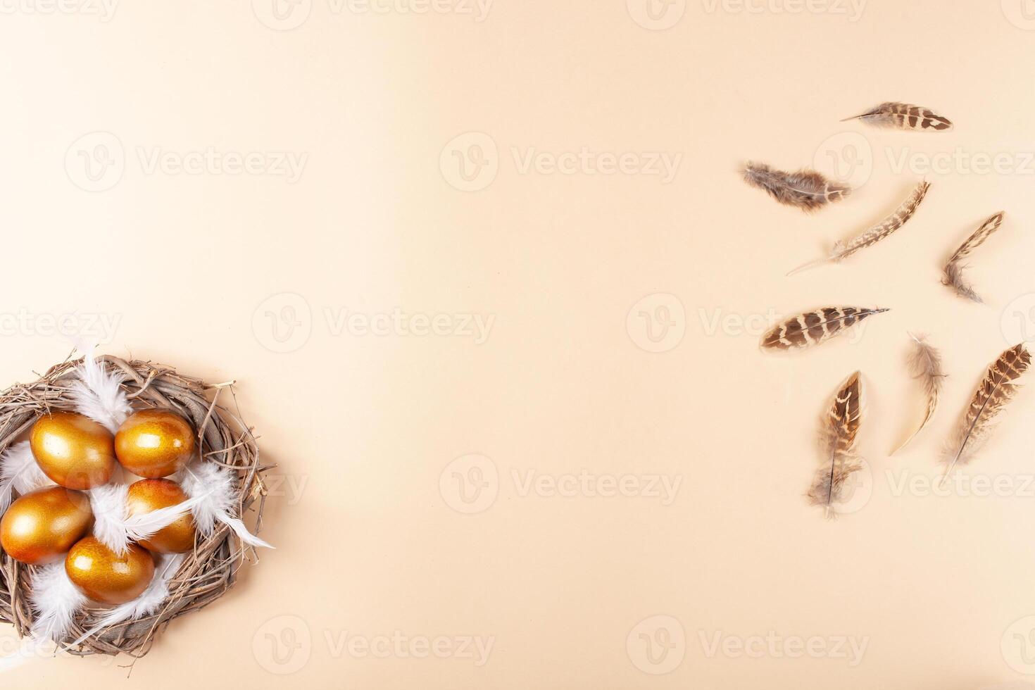 Empty space for text, a banner of happy Easter. Painted golden eggs, feathers. copy space flat lay top view Nest photo