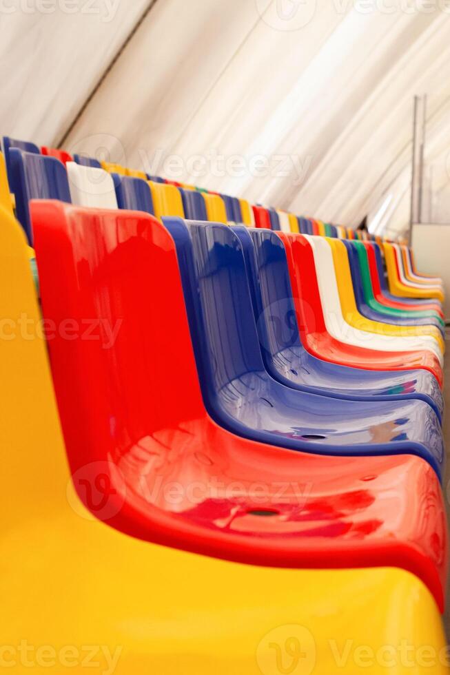 Multi-colored seats. ice rink. Sports stadium, stands for fans. photo