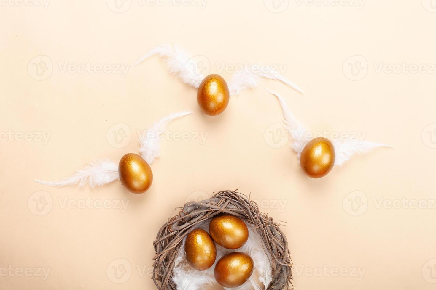 Empty space for text, a banner of happy Easter. Painted golden eggs, white feathers. copy space flat lay top view eggs with wings fly away from the nest photo