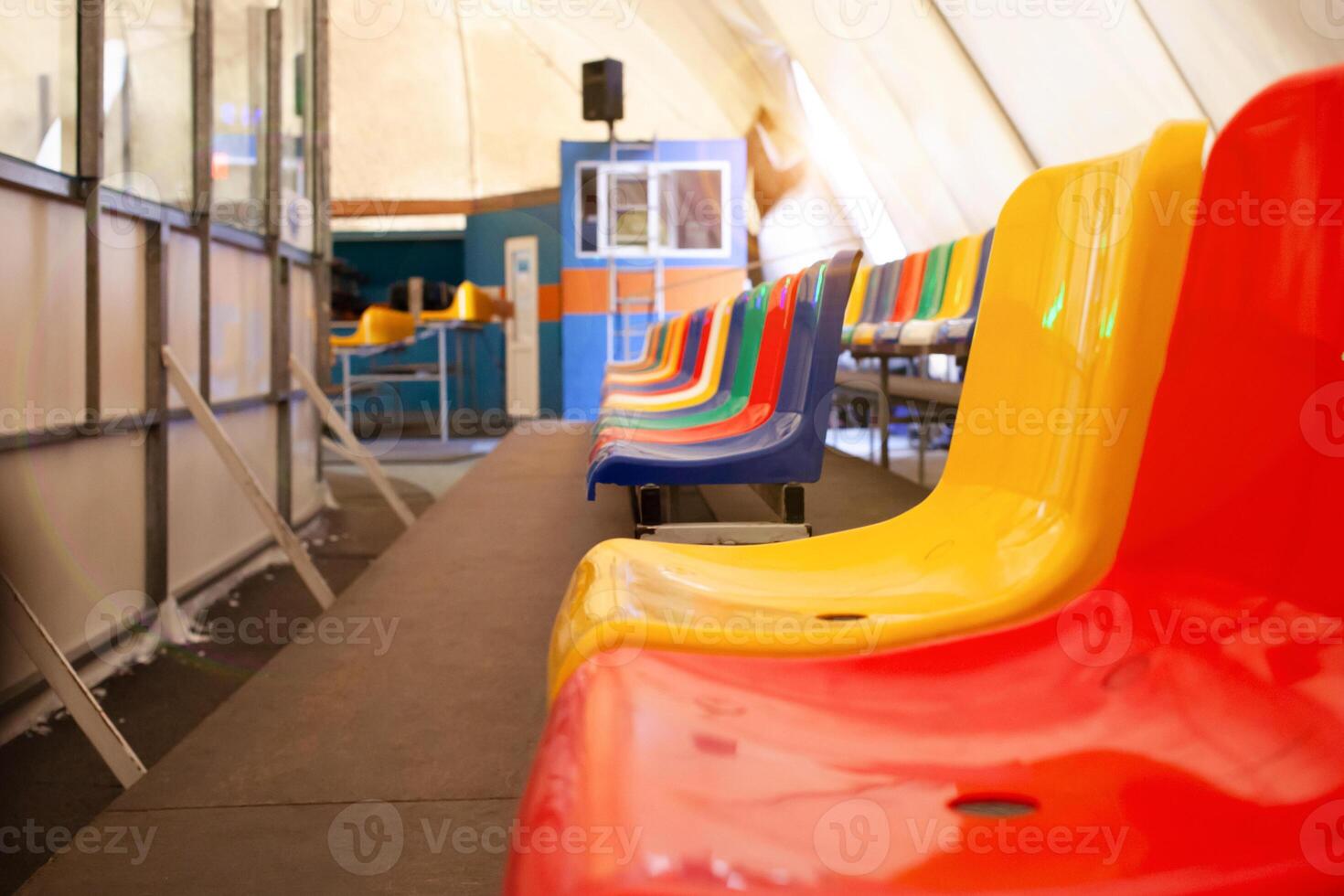 Multi-colored seats. ice rink. Sports stadium, stands for fans. photo