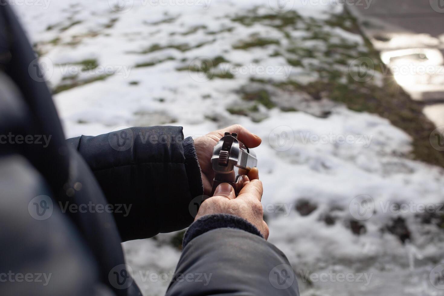 A man reloads a gun in a dash outside the door. photo