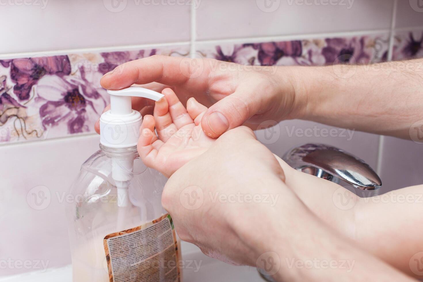 child washes hands in sink. jet of water from tap. Disinfection of hands with water. photo