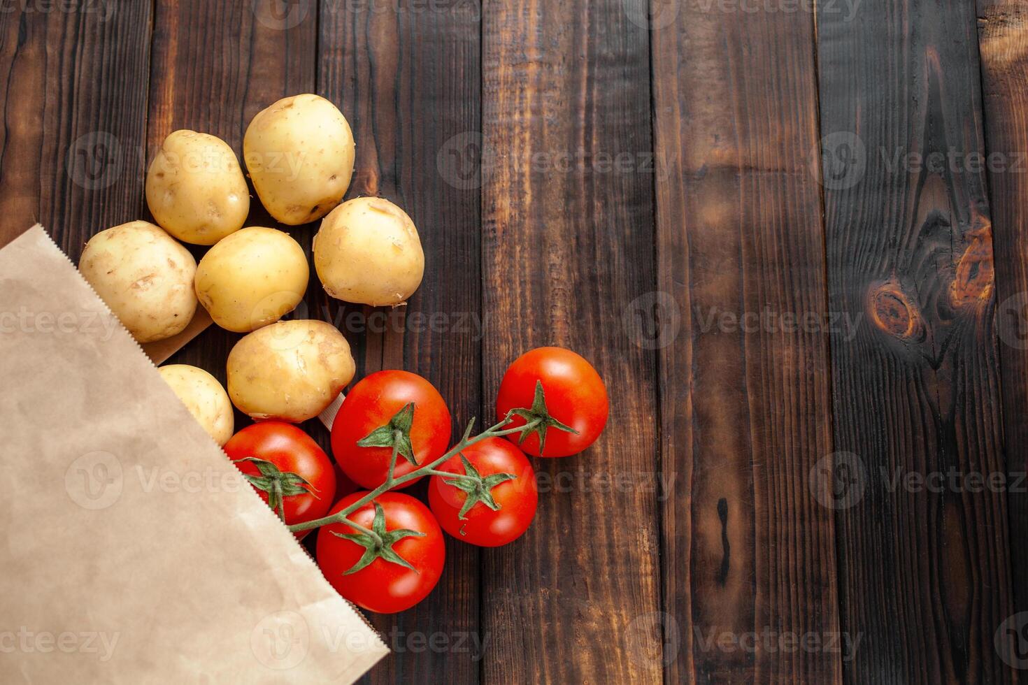 Paper bag on a wooden background, vegetables from the store photo
