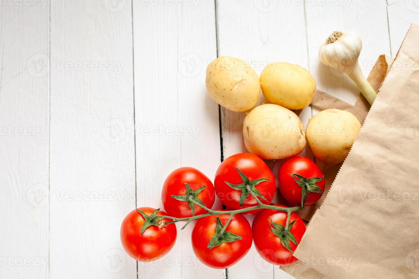 Paper bag on a wooden background, vegetables from the store photo
