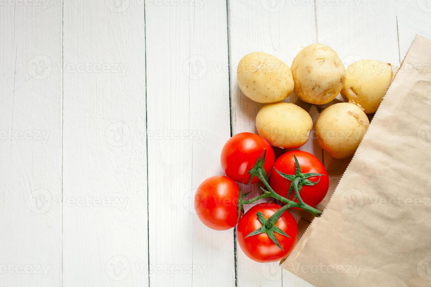 Paper bag on a wooden background, vegetables from the store photo