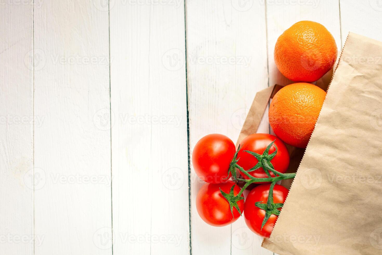 Paper bag on a wooden background, vegetables from the store photo