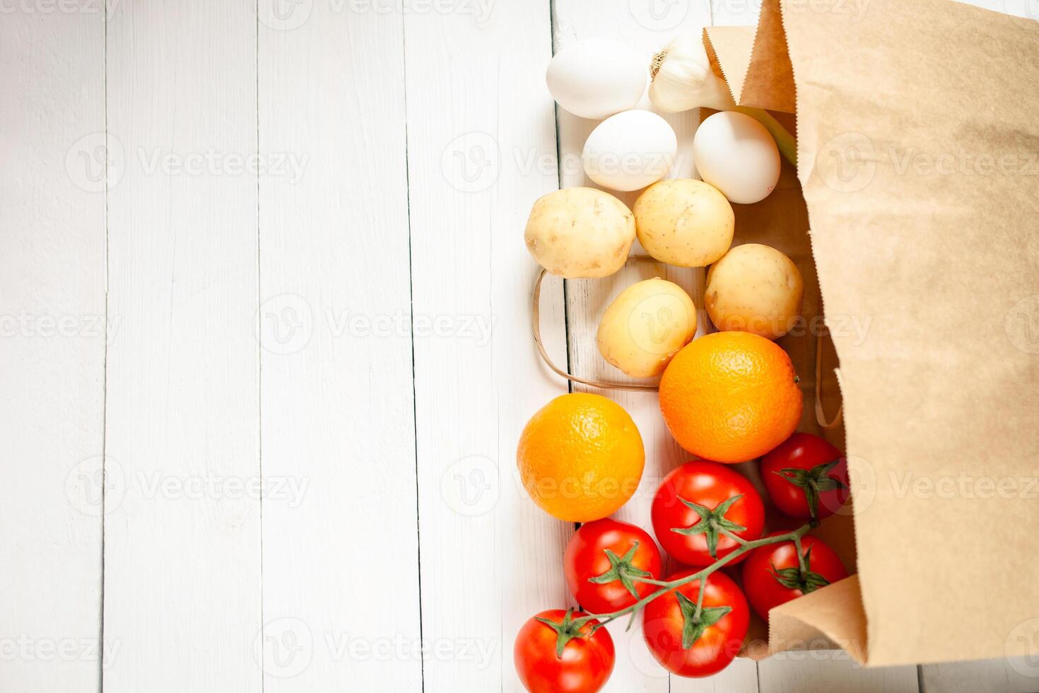Paper bag on a wooden background, vegetables from the store photo