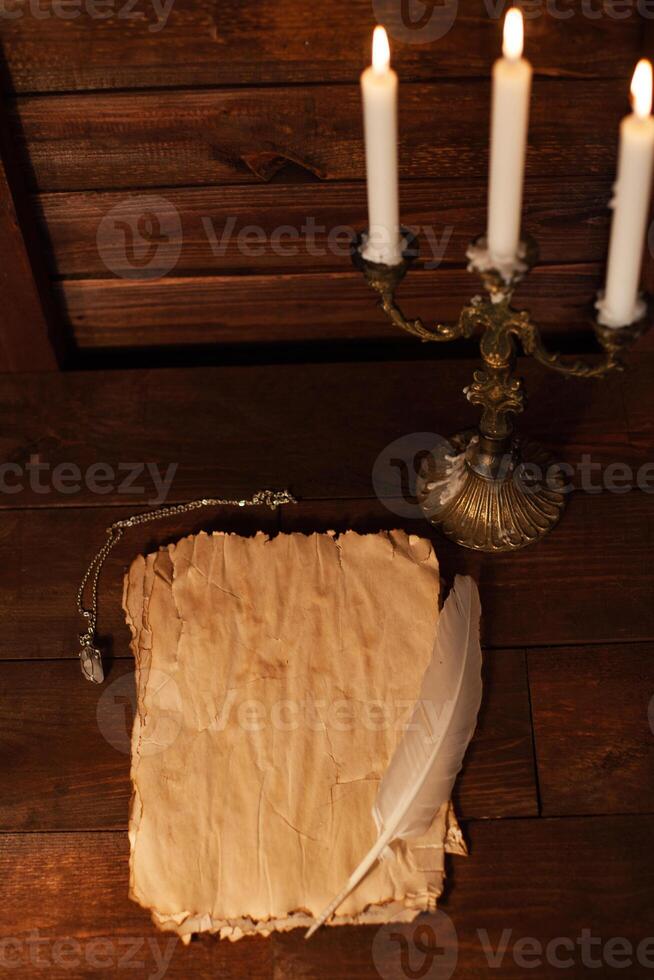 Halloween still life with burning candle on witch book and magic objects photo