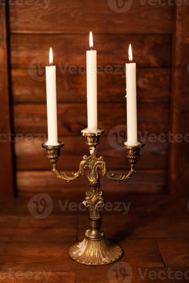Halloween still life with burning candle on witch book and magic objects photo