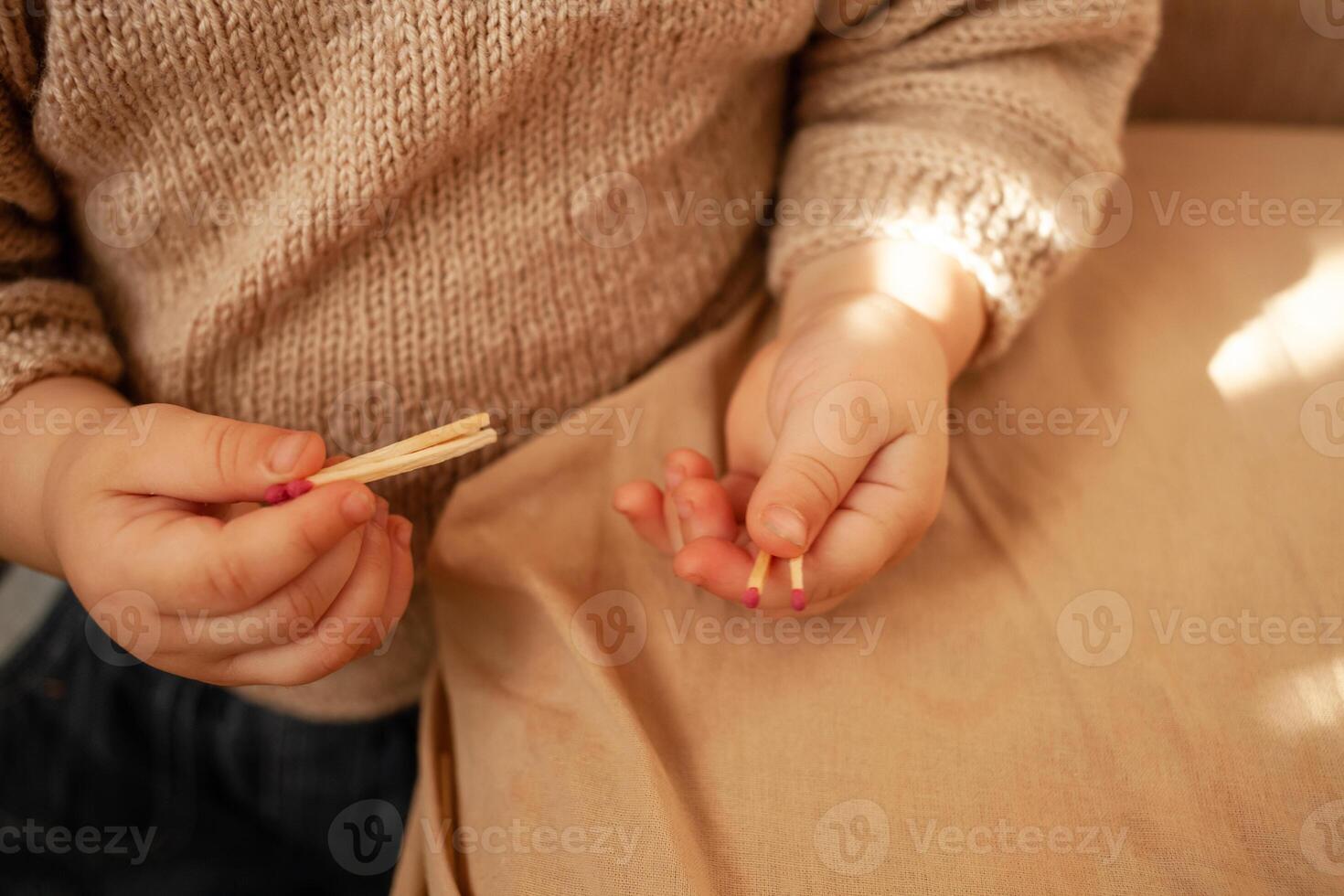 Hand holding a burning match. Match with fire and flame on a dark background. The concept of arson and fire. A burning match in his hand. Arson. Ignition of pyrotechnics. Matches and children. photo