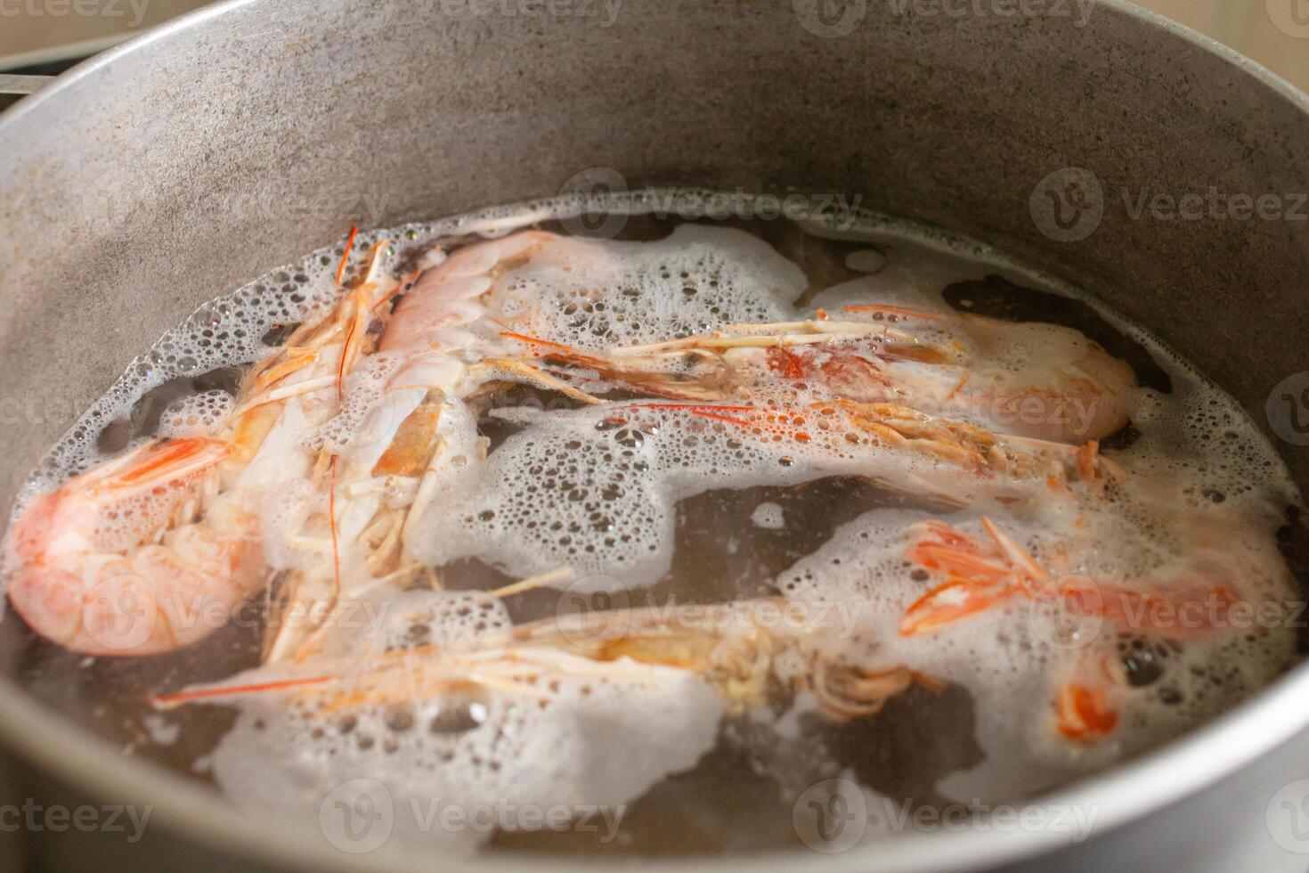 The prawns are boiled in a saucepan on a gas stove. photo