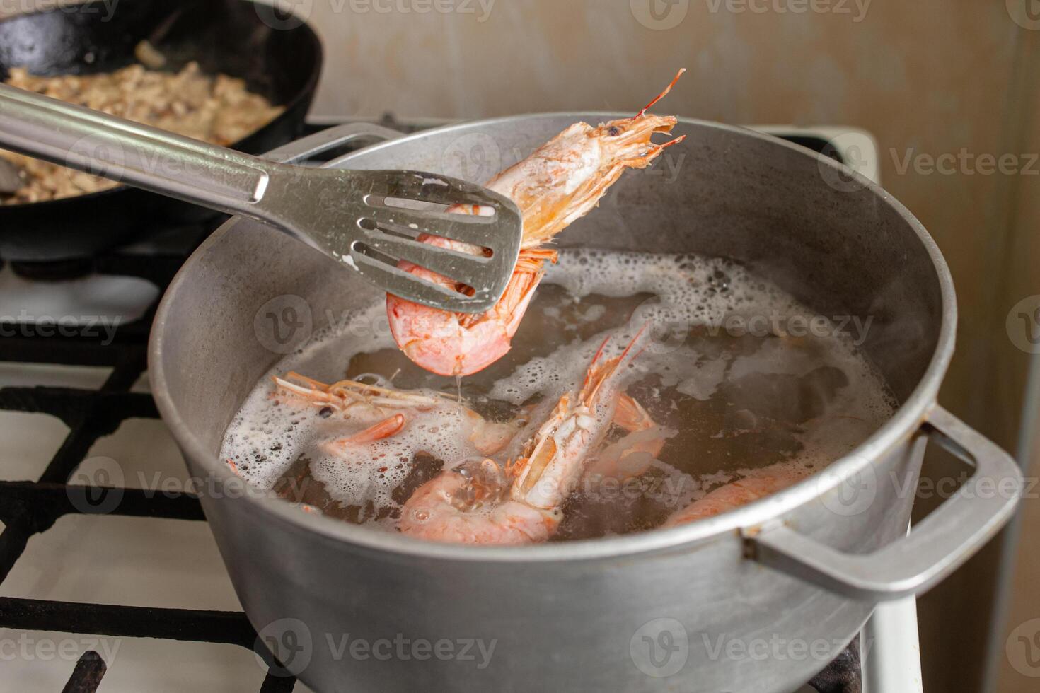 The prawns are boiled in a saucepan on a gas stove. photo