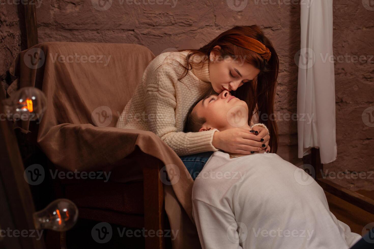 Young people in love in a photo studio. Teenagers, love. Brown interior, posing for models