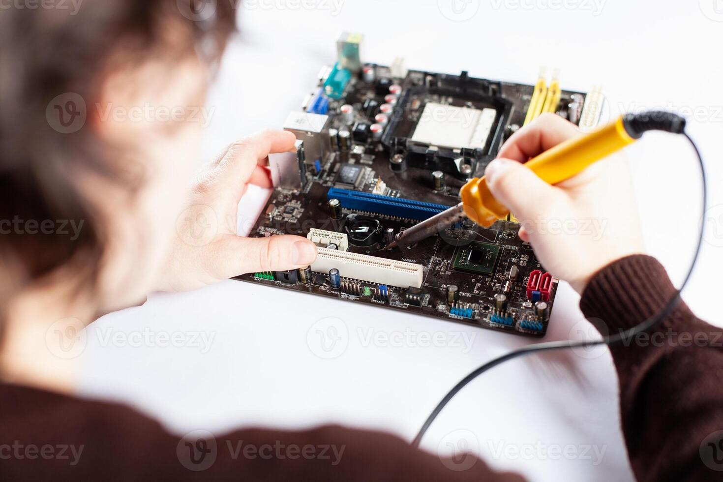 Technological background with closeup on tester checking motherboard. photo