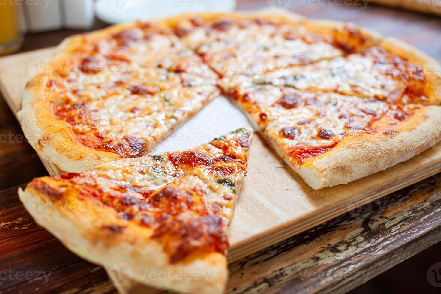 Pizza on a wooden tray cooked in the oven. Pizza margarita photo