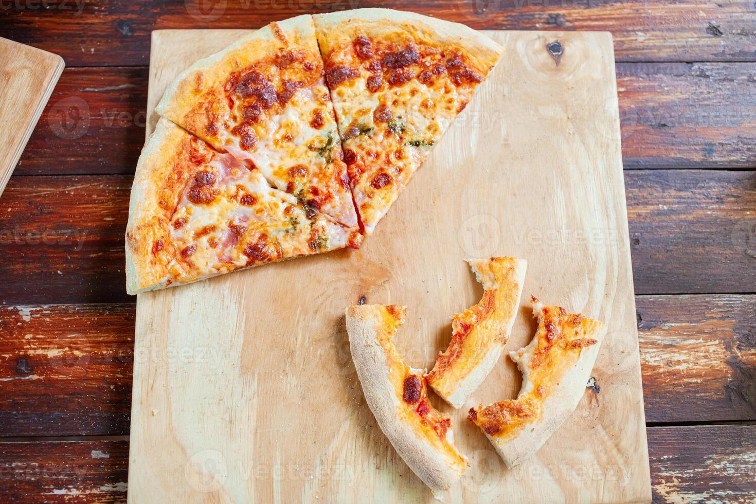 Pizza on a wooden tray. Dry crusts of the edge of the pizza photo