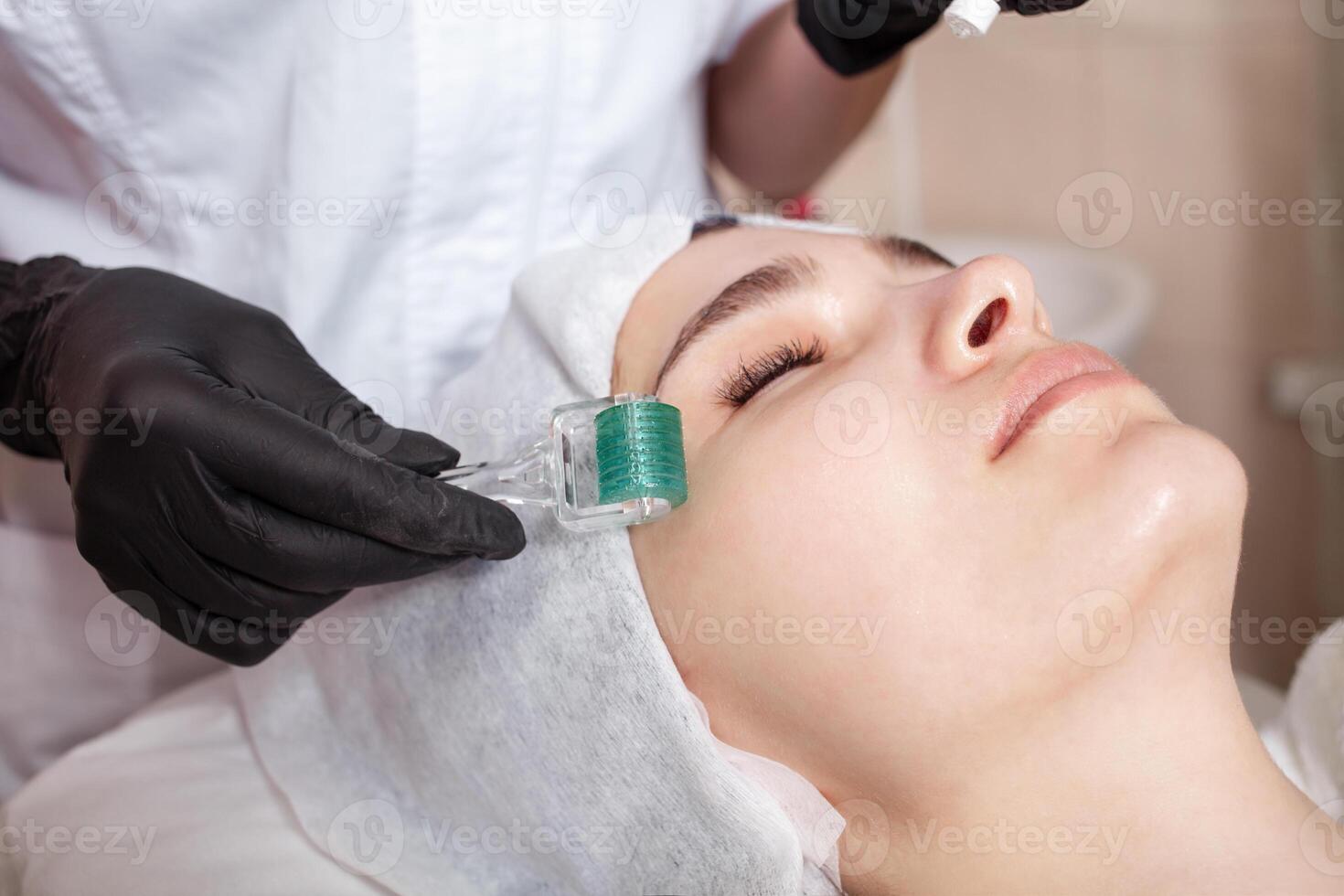 The beautician massages the face in the beauty salon photo