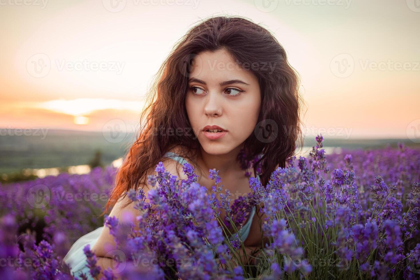 A beautiful young girl against the sunset and a beautiful sky photo