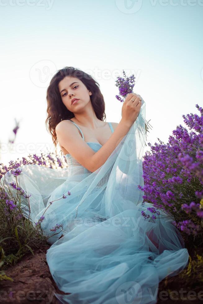 A beautiful young girl against the sunset and a beautiful sky photo