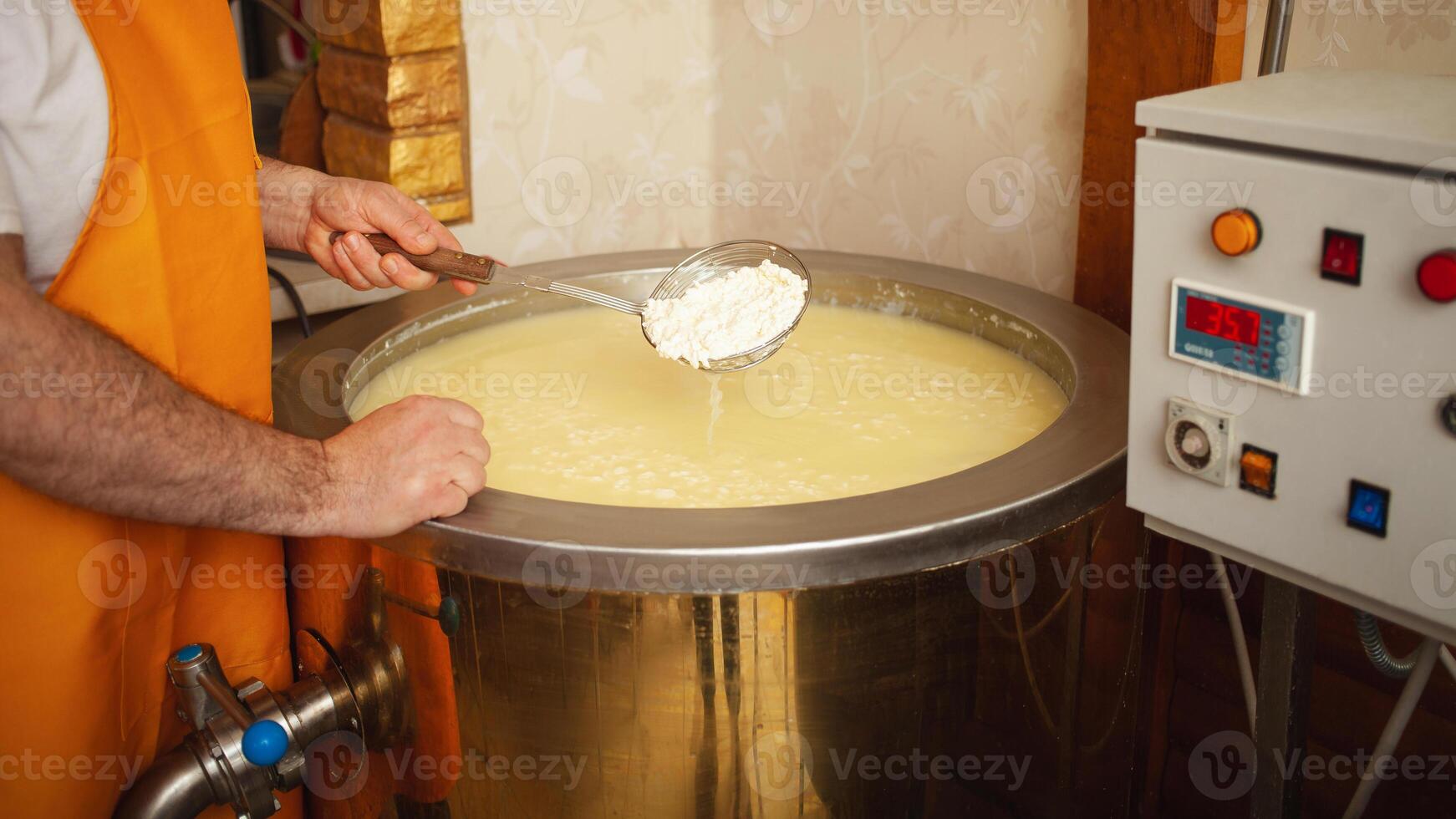 Cheese production from milk, home business, food, eco-friendly and tasty products. Serum in vat. photo