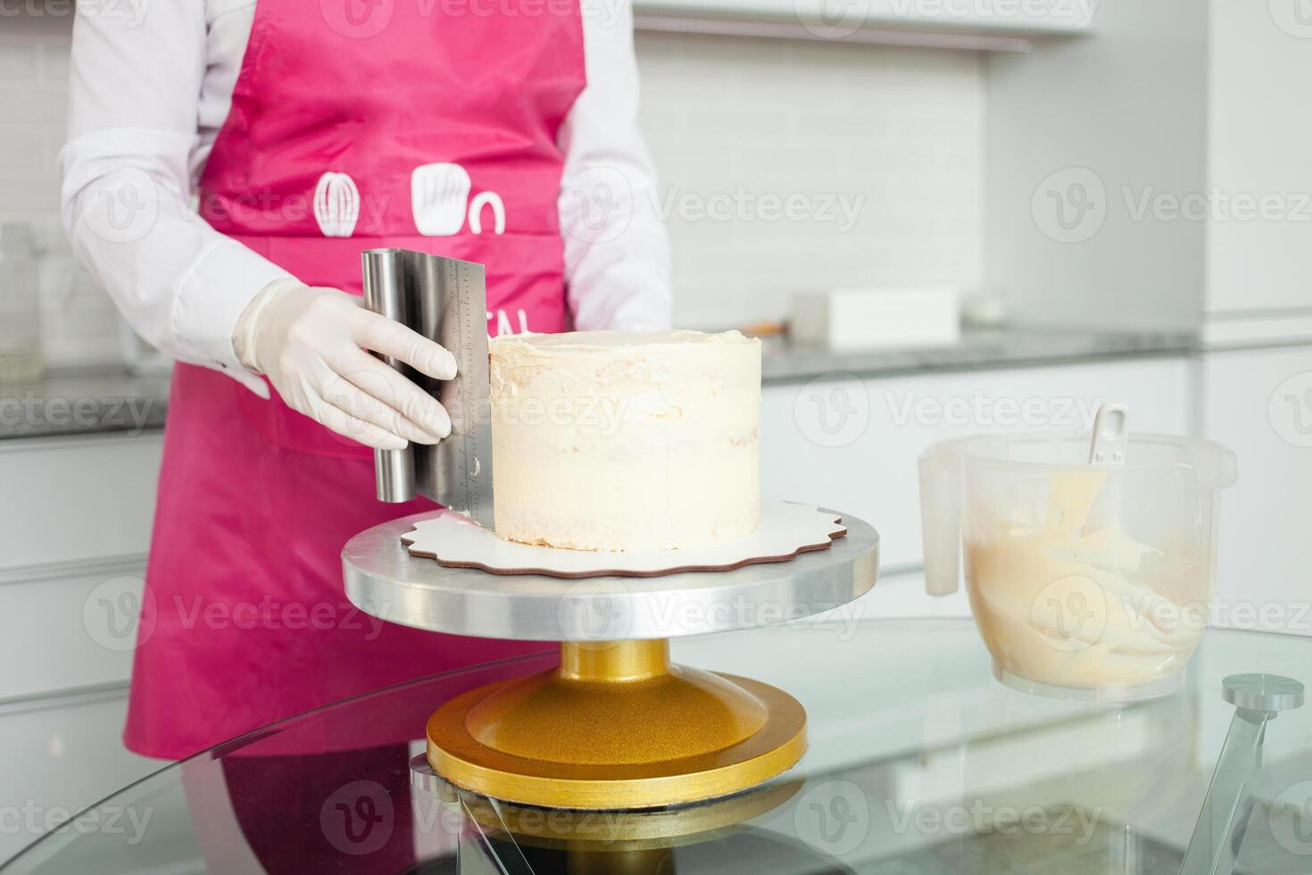 gloved pastry chef decorates cake with white chocolate. Beautiful homemade cake. Aligns photo