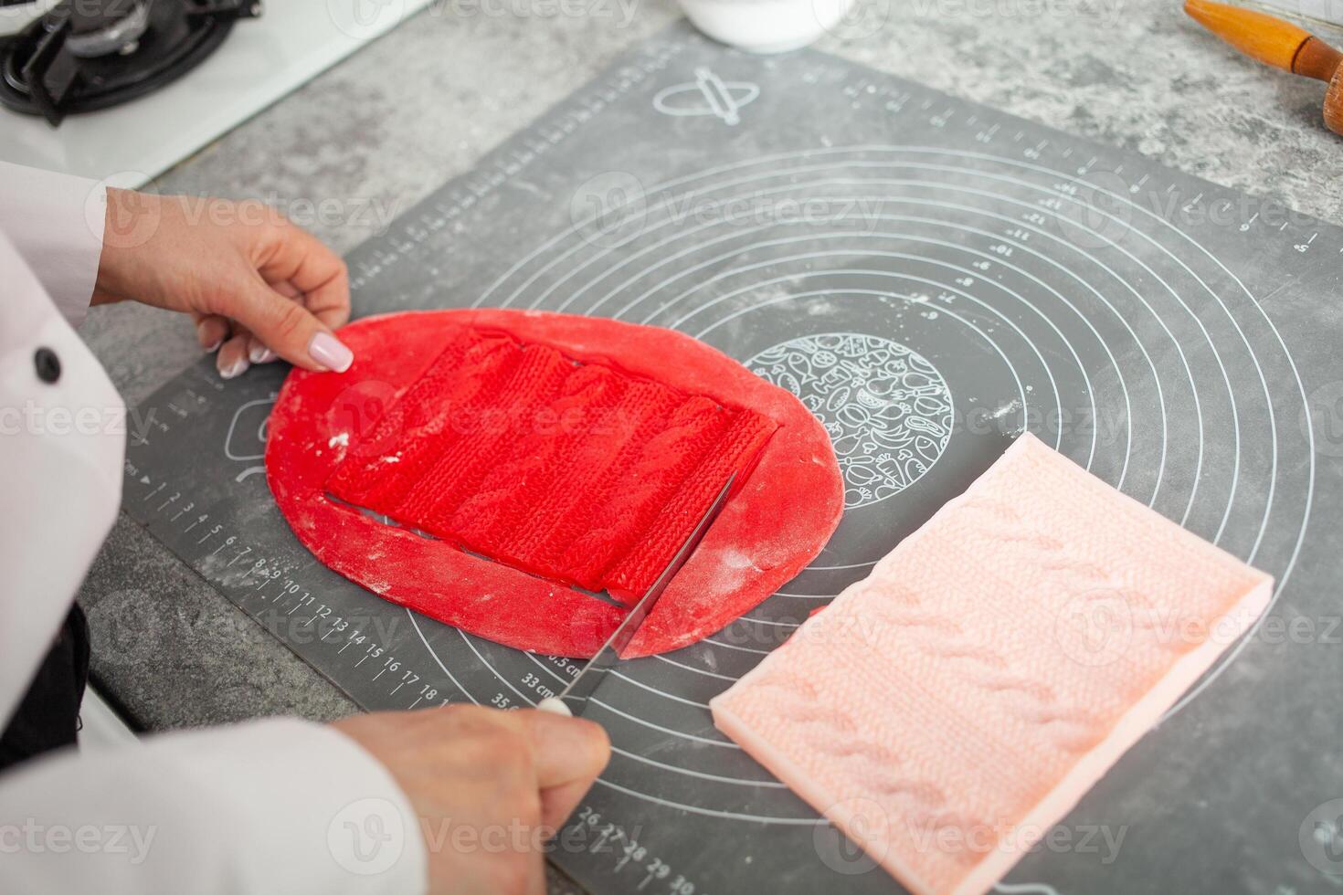 pastry chef makes mastic to decorate cake. Elastic dough, delicious pastries, cooking process. Home production, hobbies, entrepreneurship. knitted lace photo
