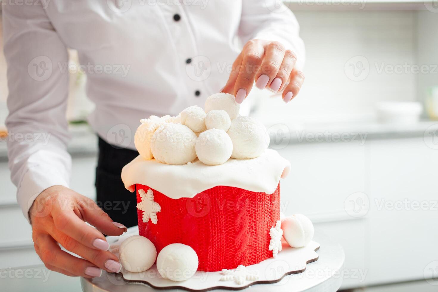 very beautiful winter cake for Christmas, New Year, holiday, birthday. Pastry chef decorates baking, home production, entrepreneur, private, indoor. Hobby. white kitchen photo