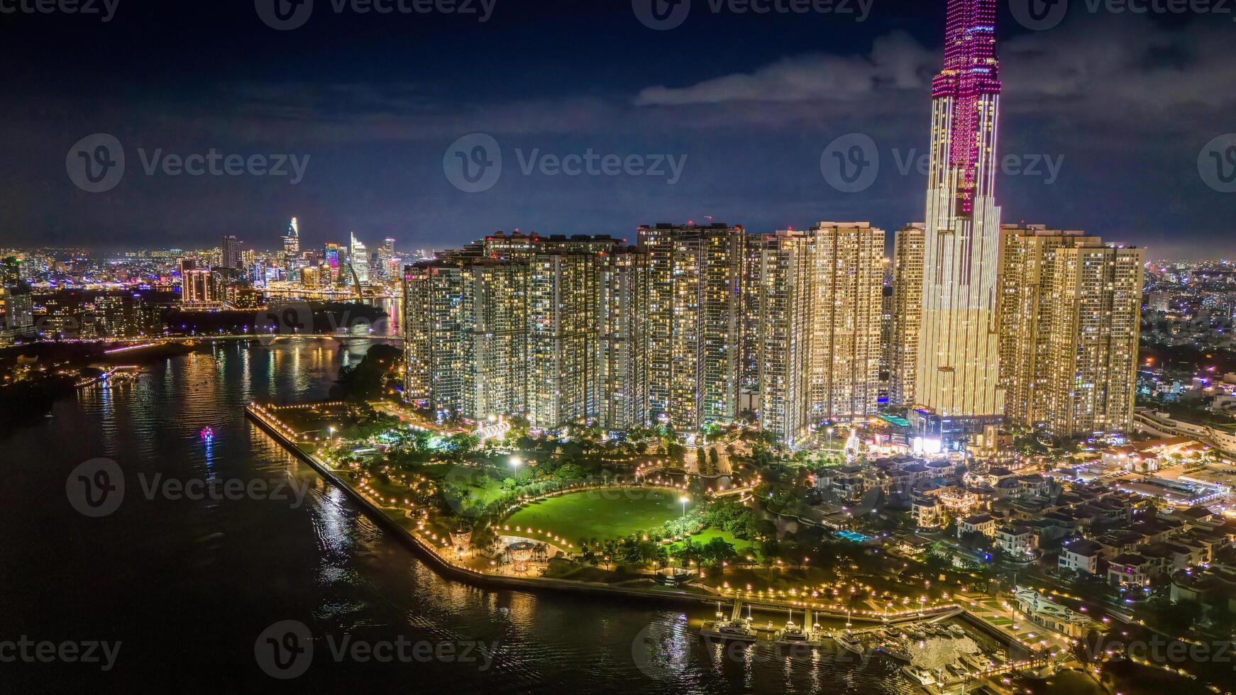 Aerial sunset view at Landmark 81 - it is a super tall skyscraper and Saigon bridge with development buildings along Saigon river, cityscape in the night photo