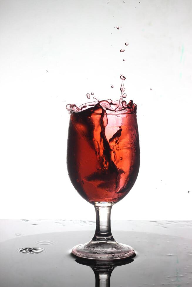 splashing cocktail into a wine glass photo