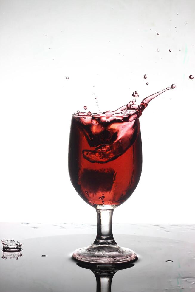 splashing cocktail into a wine glass photo