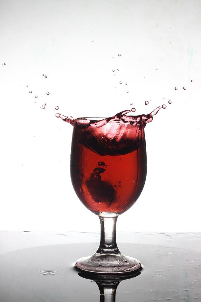 splashing cocktail into a wine glass photo