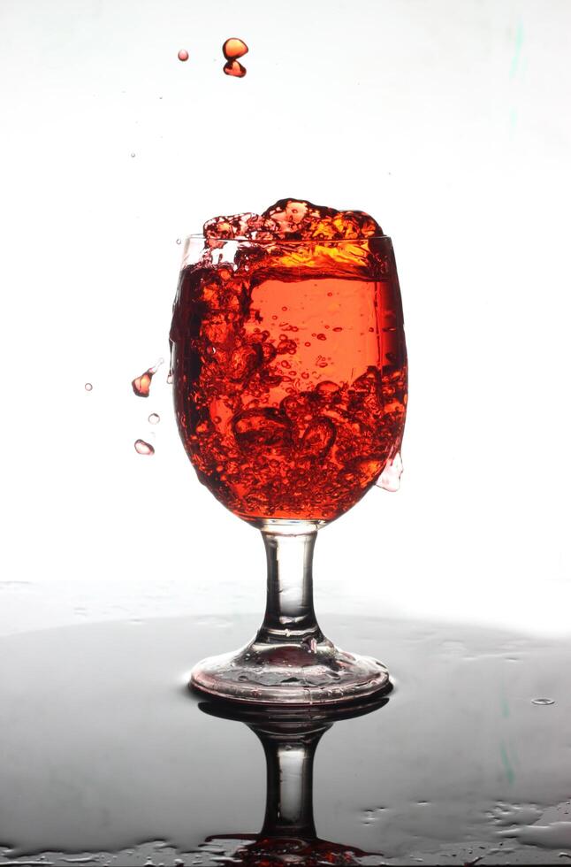 splashing cocktail into a wine glass photo