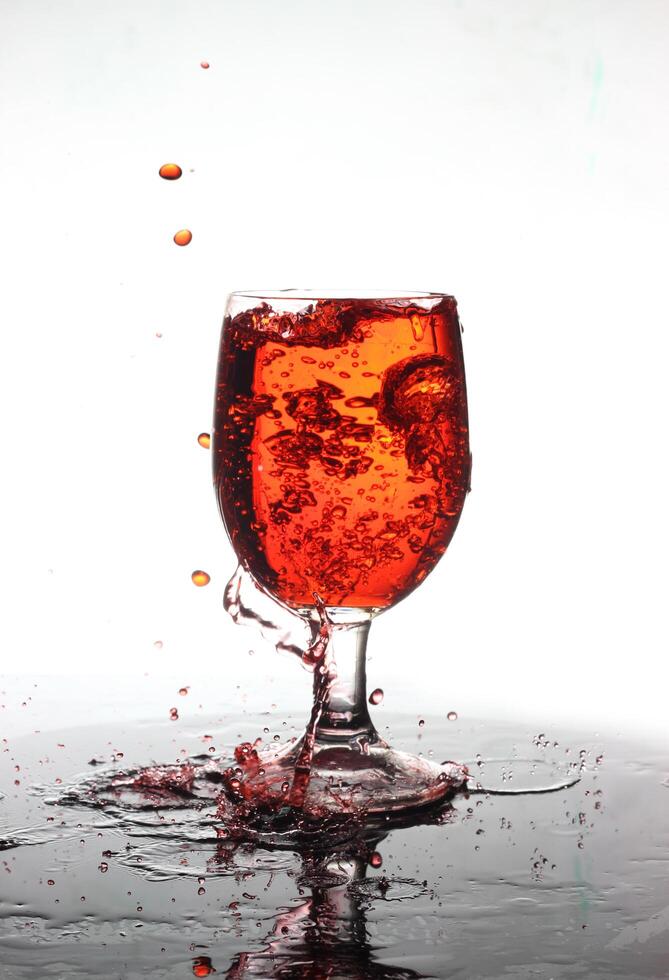 splashing cocktail into a wine glass photo