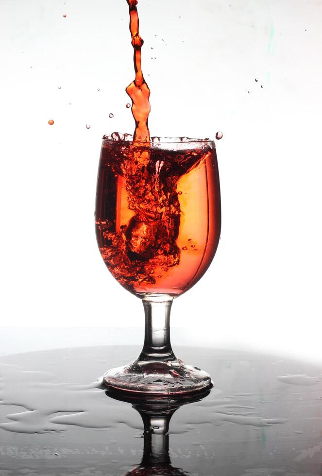 splashing cocktail into a wine glass photo